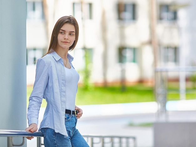 Beautiful young caucasian teenager girl on a walk in the city on a sunny summer day Copy space