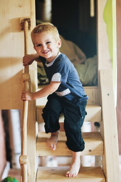 beautiful young child making first steps  and have fun in play ground