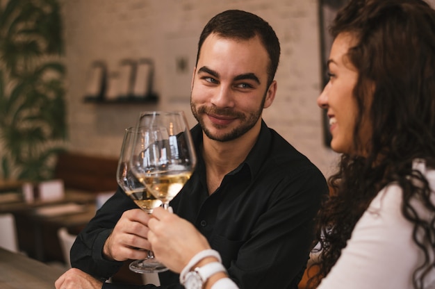 Beautiful young couple drinking wine and celebrating