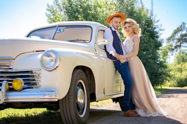 Beautiful young couple hugging near the car