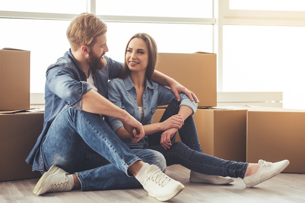 Beautiful young couple is higging at home.