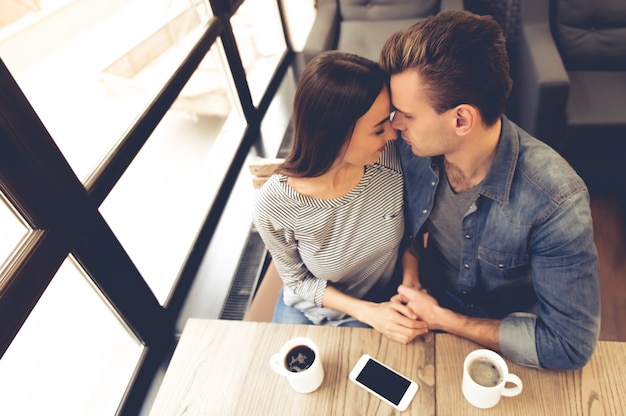 Beautiful young couple is holding hands and touching