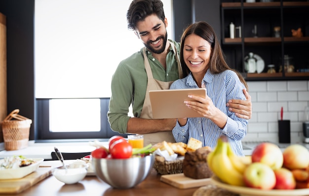 Beautiful young couple in the kitchen while cooking