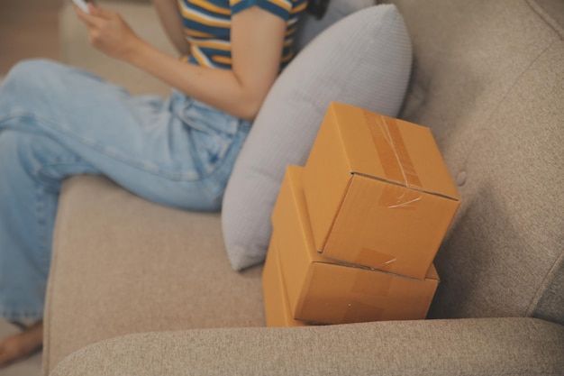 Beautiful young couple in love having fun unpacking things from cardboard boxes while moving in together in their new apartment