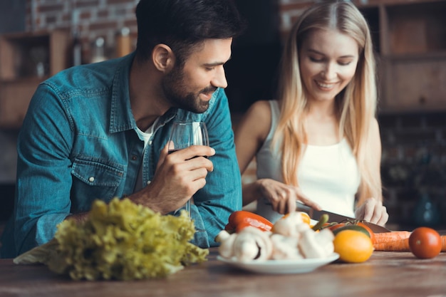 Beautiful young couple preparing a healthy meal together while spending free time at home