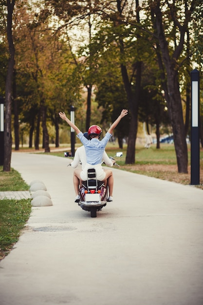  beautiful young couple riding scooter