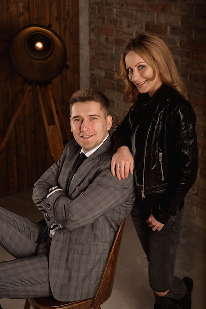 Beautiful young couple standing close to each other and looking at camera