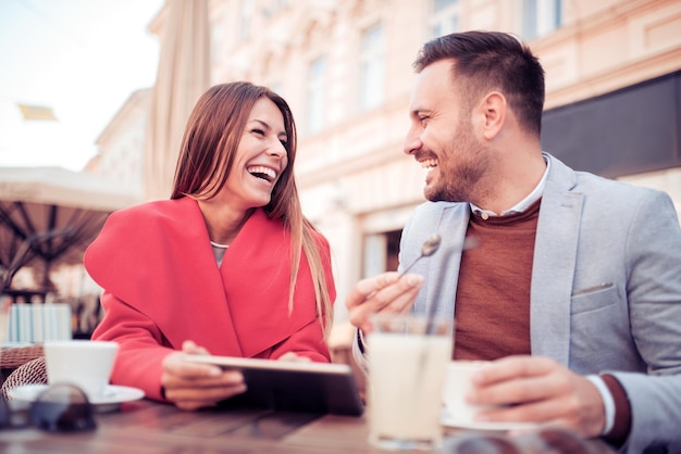 Beautiful young couple using tablet