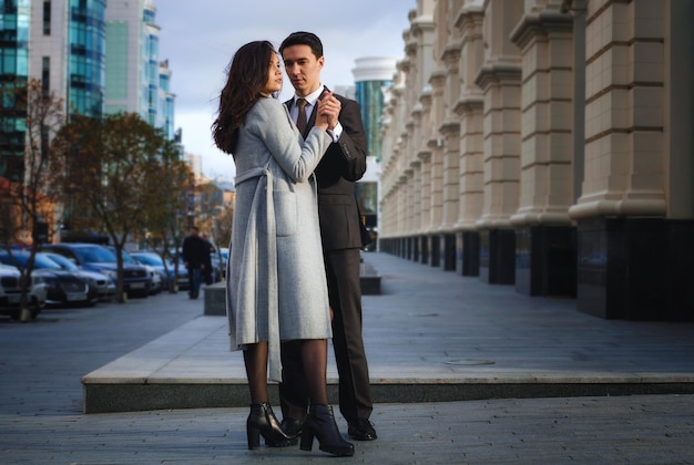 A beautiful young couple walking around the cityman and woman in business style