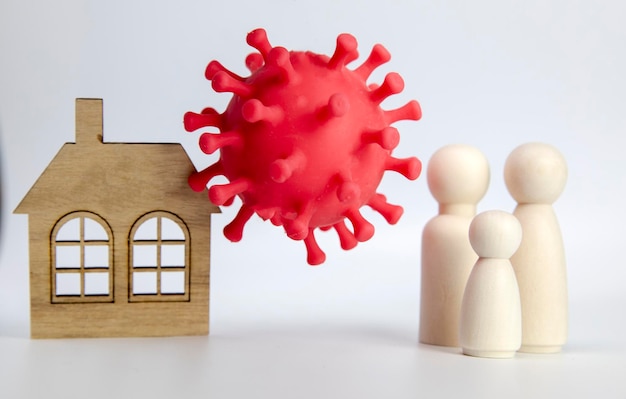 Beautiful young couple with child standing next to there house with bacteria covid  happy and health...