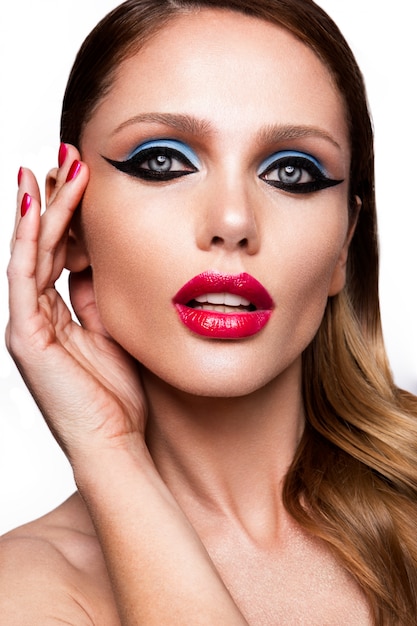 Beautiful young female face with bright fashion multicolored make-up