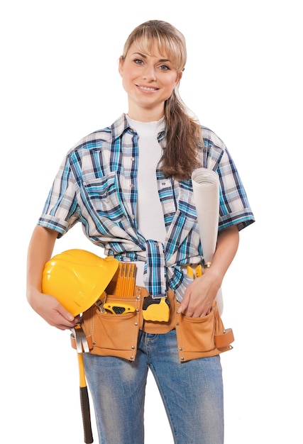 Beautiful young female worker wearing working clothes with tools isolated