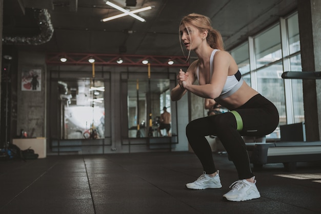 Beautiful young fitness woman working out at the gym