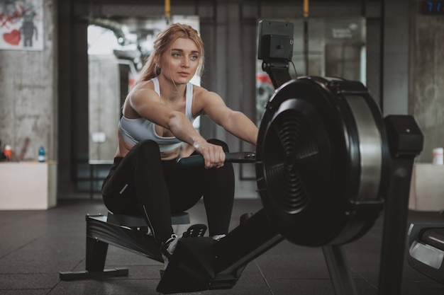 Beautiful young fitness woman working out at the gym