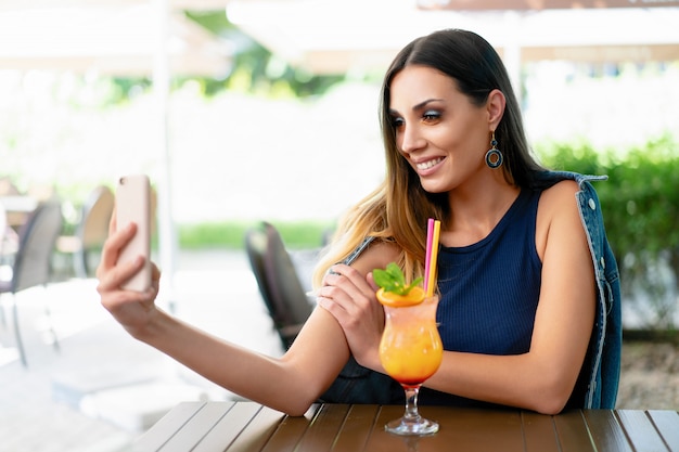 A beautiful young girl drinking an exotic summer cocktail 