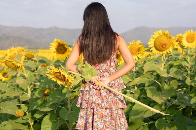 Beautiful young girl enjoy time at the field flowers