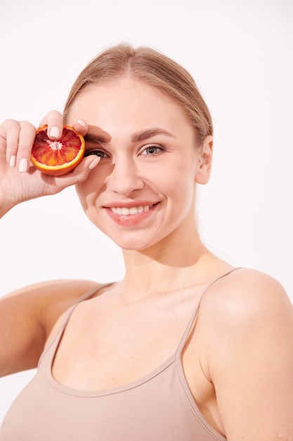 Beautiful young girl enjoying juicy fruits