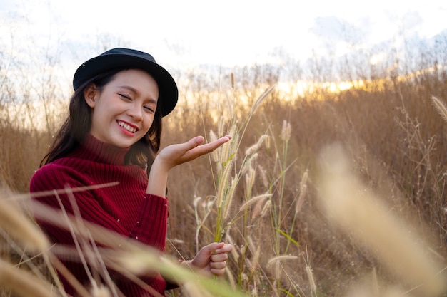 Beautiful young girl having happy at grass field