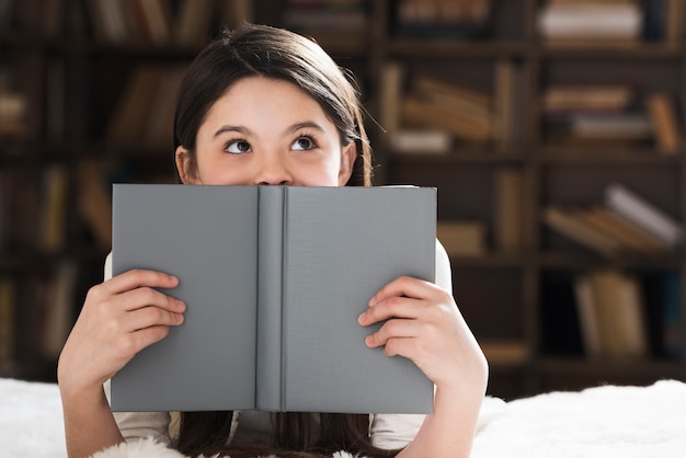 Beautiful young girl holding a book