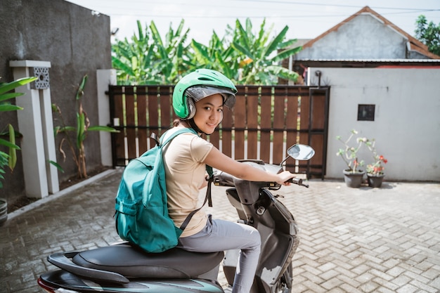 Beautiful young girl is sitting on the motorcycle