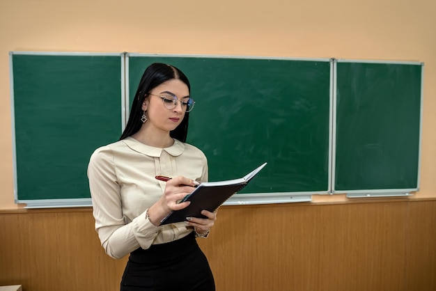 Beautiful young girl in a new school teacher at the first lesson