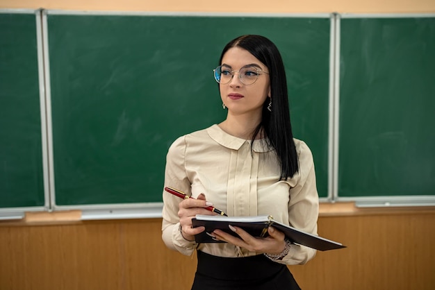 Beautiful young girl in a new school teacher at the first lesson