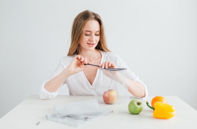 Beautiful young girl packs the vegetables and fruits in a reusable cloth bag. The concept of zero waste. Toning.