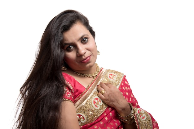 Beautiful young girl posing in Indian traditional saree on white.