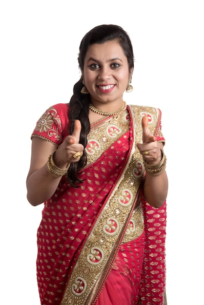 Beautiful young girl posing in Indian traditional saree on white.