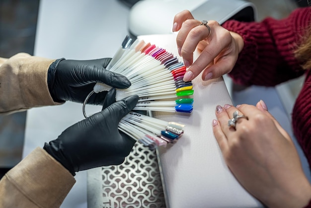 Beautiful young girl sitting on a manicure in a prestigious salon