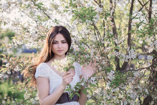 Beautiful young girl in spring garden