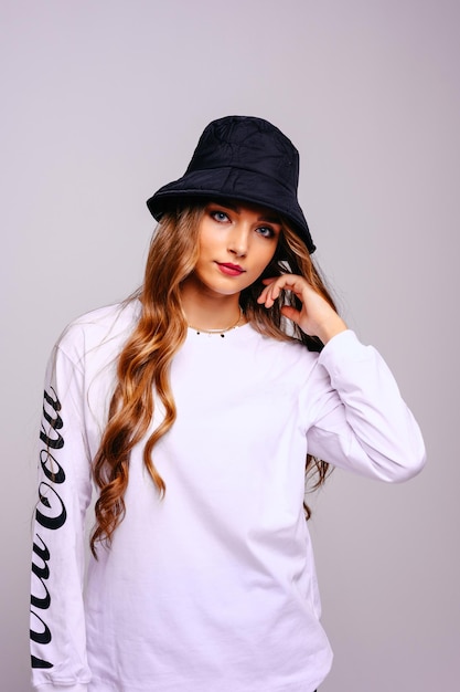 A beautiful young girl straightens her hair