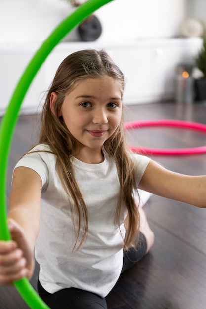 Beautiful young girl using hula hop