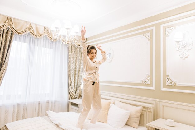 Beautiful young girl wearing pajamas in a luxurious room