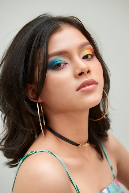 Beautiful young girl with bright multicolored makeup