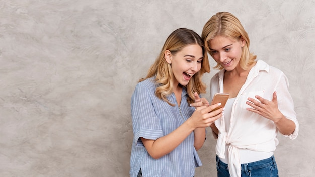 Beautiful young girls checking a message