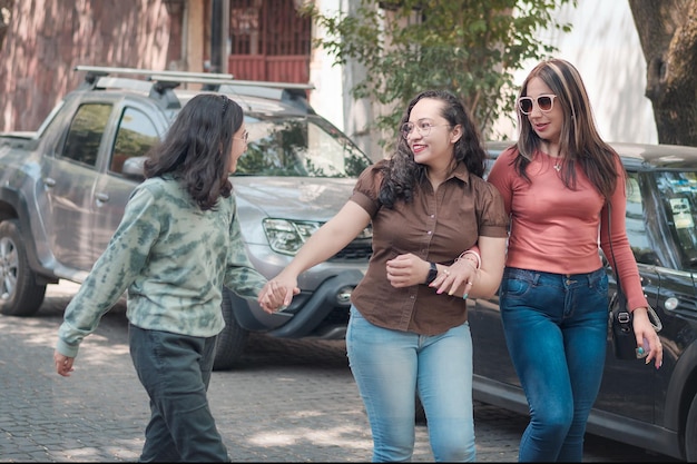 Beautiful and young girls having fun and walking around the city happy and smiling on a sunny day