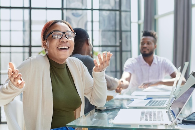 Beautiful young grinning professional Black woman in office