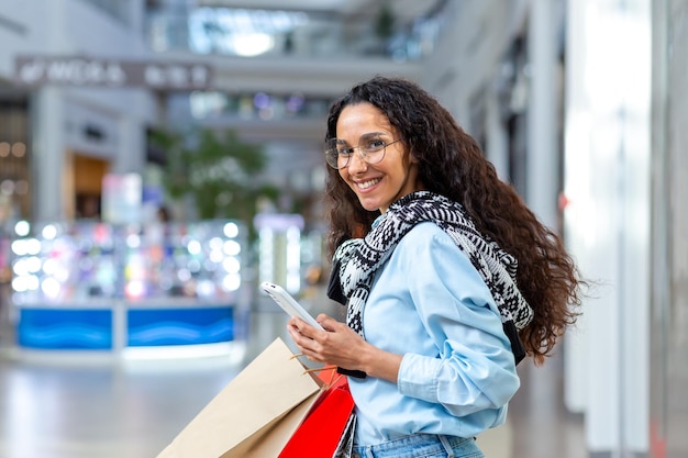 Beautiful young latin american girl student shopping in a supermarket stores have a fun weekend he