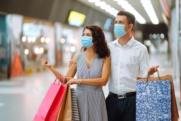 Beautiful young loving couple shopping together Black friday concept