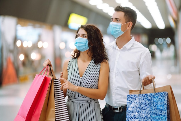 Beautiful young loving couple shopping together Black friday concept