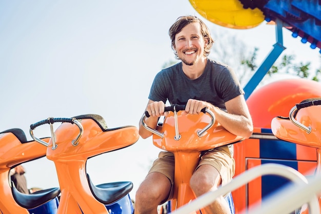 Beautiful, young man having fun at an amusement park