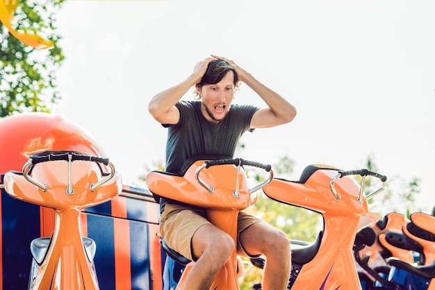 Beautiful, young man having fun at an amusement park