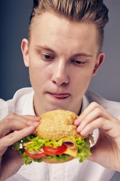 Beautiful Young man looking at a fresh burger