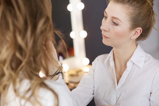 Beautiful young model woman getting fashion makeup