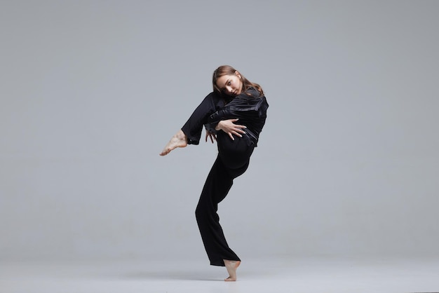 Beautiful young modern dancer or fitness dancer on a white isolated background