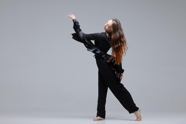 Beautiful young modern dancer or fitness dancer on a white isolated background