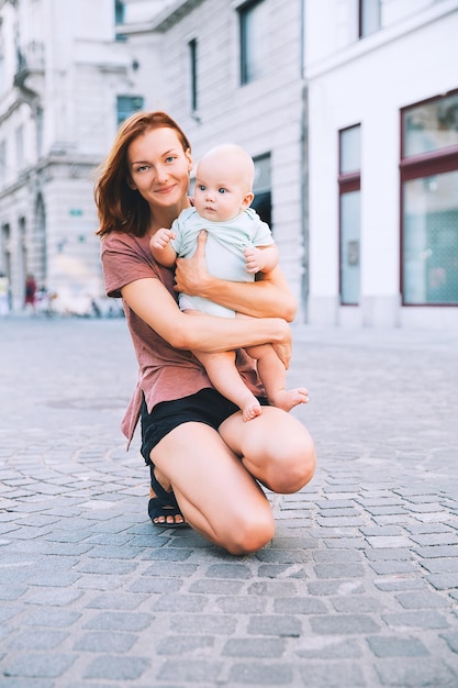 Beautiful young mother with baby child spend time in the old town of Ljubljana Slovenia Europe