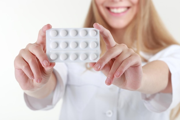 A beautiful young nurse offering pills