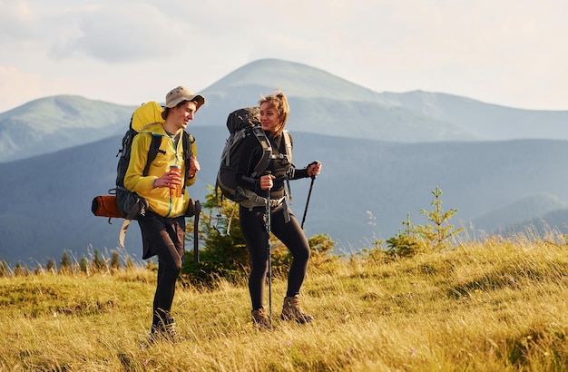 Beautiful young people travel together Majestic Carpathian Mountains Beautiful landscape of untouched nature